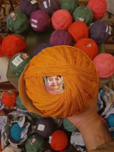4 PC pinna of orange cotton dor held in hand